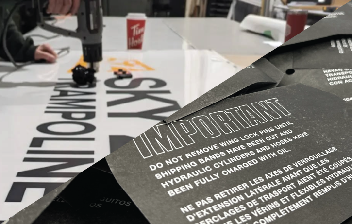A piture showing vinyl being removed from a large sign, and important non-tear tags to be attached metal parts